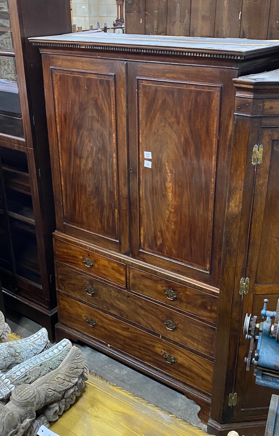 A George III mahogany linen press, converted to a hanging wardrobe, width 116cm, depth 55cm, height 195cm